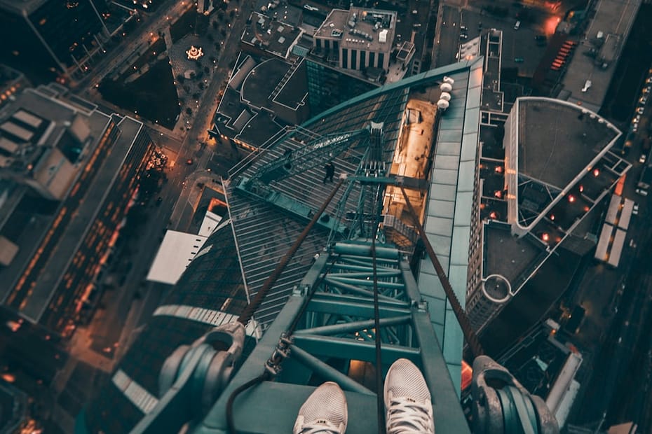 person standing on gray steel frame on top of building